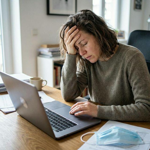 Person experiencing severe brain fog and fatigue at a desk